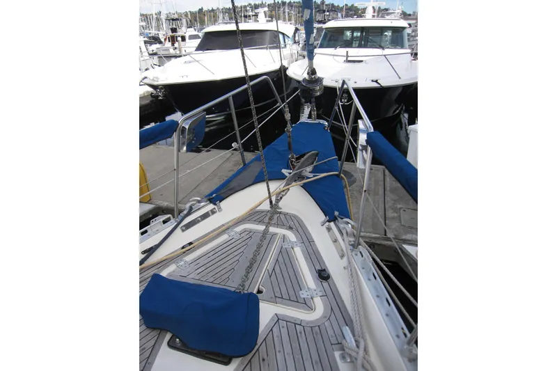 Slide: The Image of 1983 Nauticat 43 sailboat docked, featuring teak deck and blue covers. - 35