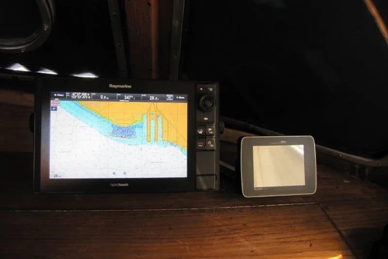 Slide: The Image of Electrical setup inside a 1983 Nauticat 43 sailboat, featuring a computer and wiring. - 4