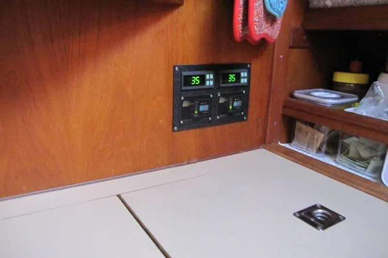 Slide: The Image of Cozy cabin interior of 1983 Nauticat 43 sailboat with plaid bedding and wooden furnishings. - 7
