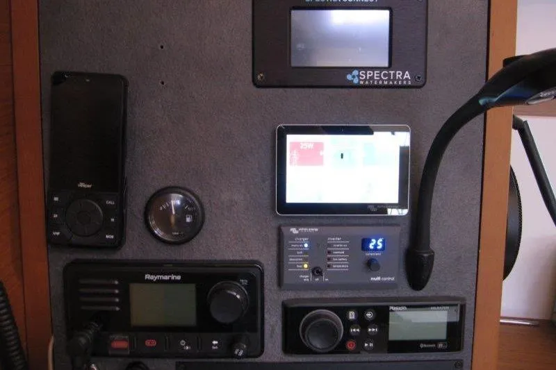 Slide: The Image of Control panel of 2022 Jeanneau Sun Odyssey 349 yacht with navigation and communication equipment. - 12