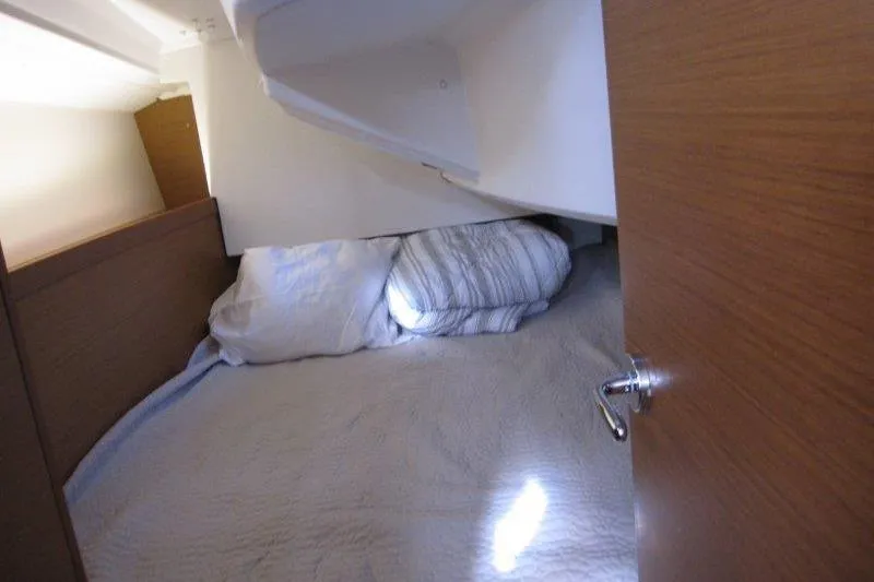 Slide: The Image of Cozy cabin interior of 2022 Jeanneau Sun Odyssey 349 sailboat with bed and pillows. - 15