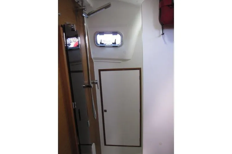 Slide: The Image of Interior of 2022 Jeanneau Sun Odyssey 349 sailboat, featuring a compact bathroom with shower. - 18