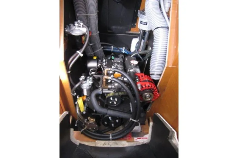 Slide: The Image of Engine compartment of a 2022 Jeanneau Sun Odyssey 349 sailboat, showcasing mechanical components. - 22