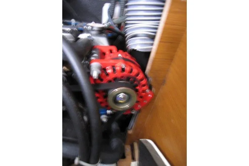 Slide: The Image of Engine component of 2022 Jeanneau Sun Odyssey 349 sailboat, featuring a red alternator. - 23