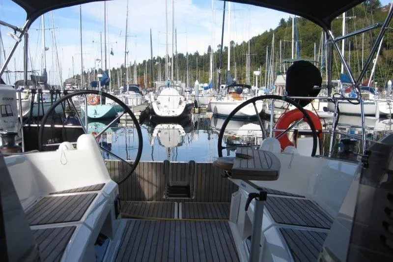 Slide: The Image of Cockpit view of 2022 Jeanneau Sun Odyssey 349 in a marina setting. - 25