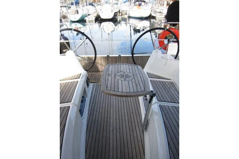Slide: The Image of Jeanneau Sun Odyssey 349 (2022) yacht cockpit with wooden deck and dual steering wheels. - 27