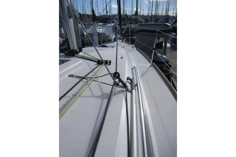 Slide: The Image of 2022 Jeanneau Sun Odyssey 349 sailboat deck with rigging and marina background. - 37