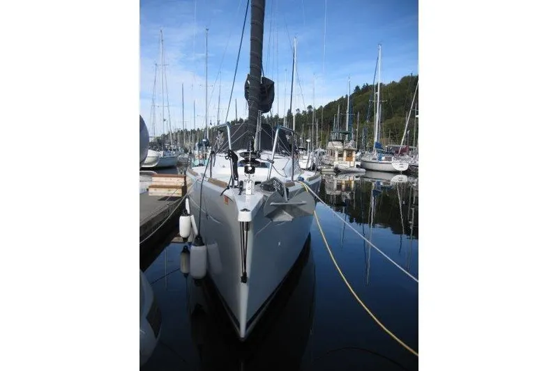 Slide: The Image of 2022 Jeanneau Sun Odyssey 349 sailboat docked in a marina, surrounded by other boats. - 45