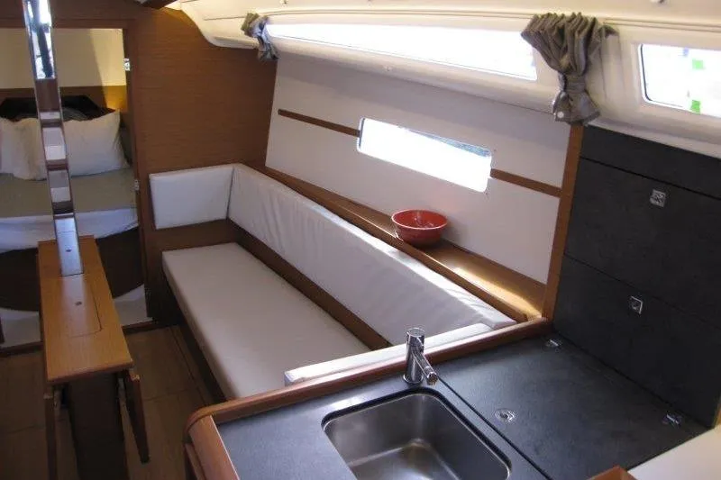 Slide: The Image of Interior of 2022 Jeanneau Sun Odyssey 349 yacht with modern kitchen and seating area. - 5
