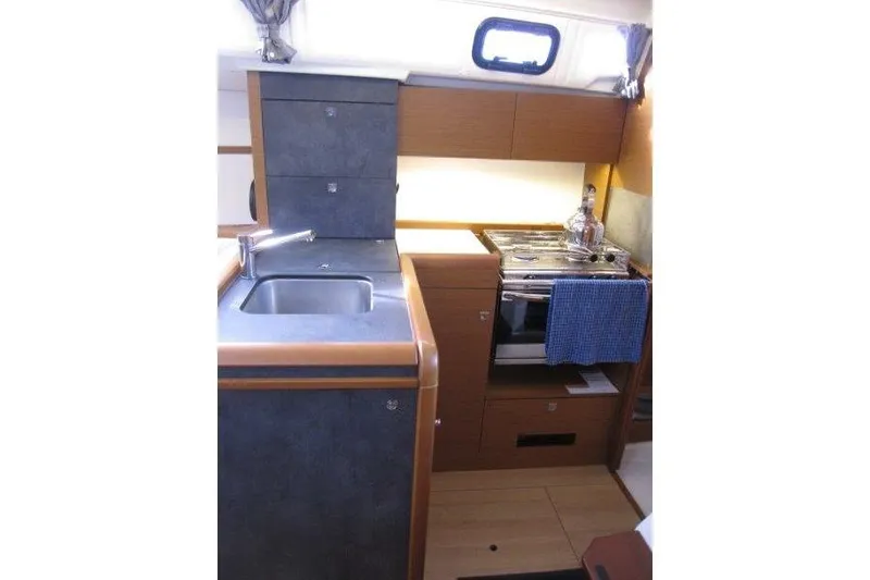 Slide: The Image of Interior view of 2022 Jeanneau Sun Odyssey 349 yacht kitchen area. - 6