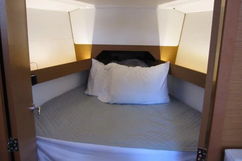 Slide: The Image of Cozy cabin interior of 2022 Jeanneau Sun Odyssey 349 sailboat with comfortable bedding. - 7