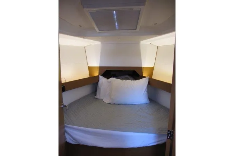 Slide: The Image of Cozy cabin interior of 2022 Jeanneau Sun Odyssey 349 sailboat with bed and pillows. - 8