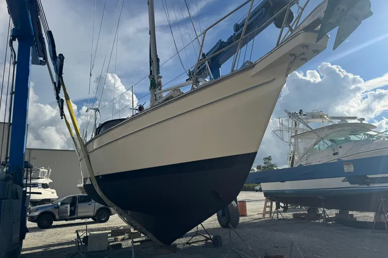 Slide: The Image of Sailboat Island Packet 380, 2000 model, in dry dock with blue sky background. - 13