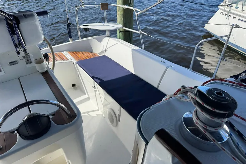 Slide: The Image of Cockpit of 1992 Beneteau Oceanis 370 sailboat with seating and steering wheel. - 14