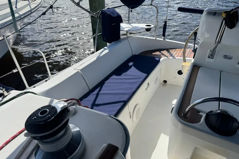 Slide: The Image of Cockpit of 1992 Beneteau Oceanis 370 sailboat with blue cushions and steering wheel. - 15