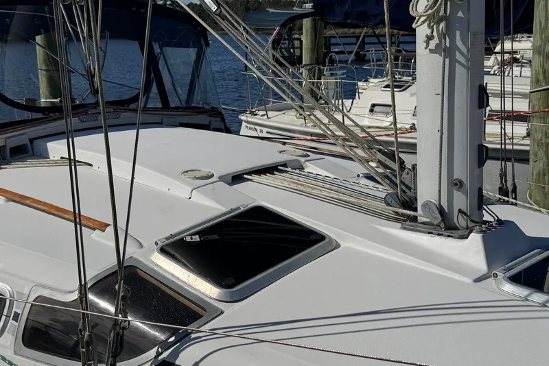 Slide: The Image of 1992 Beneteau Oceanis 370 sailboat deck with rigging and hatches in marina. - 18