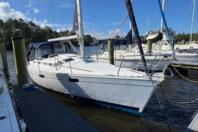 Slide: The Image of 1992 Beneteau Oceanis 370 sailboat docked at a marina under clear skies. - 2