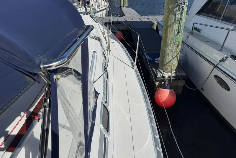 Slide: The Image of 1992 Beneteau Oceanis 370 sailboat docked, featuring deck and mooring details. - 21
