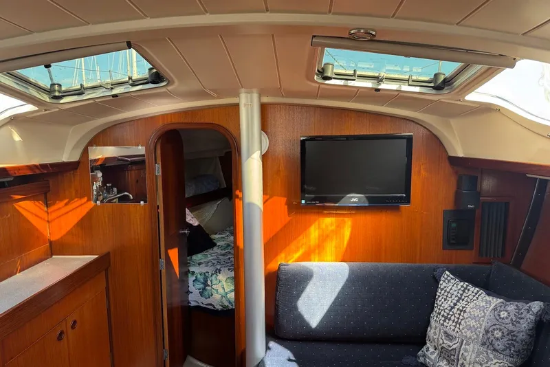 Slide: The Image of Interior of 1992 Beneteau Oceanis 370 yacht with cozy seating and TV. - 26