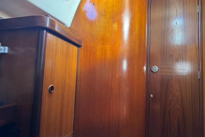 Slide: The Image of Interior of 1992 Beneteau Oceanis 370 sailboat with polished wooden cabinetry and door. - 28