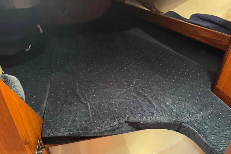 Slide: The Image of Interior cabin of 1992 Beneteau Oceanis 370 sailboat with dark fabric bedding. - 29