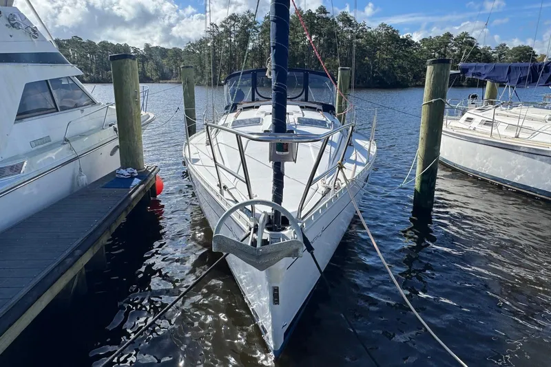 Slide: The Image of 1992 Beneteau Oceanis 370 sailboat docked at a marina, surrounded by water and trees. - 3
