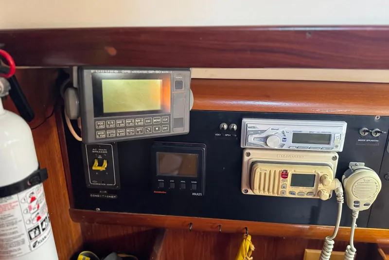 Slide: The Image of Control panel of a 1992 Beneteau Oceanis 370 sailboat with navigation and communication equipment. - 31