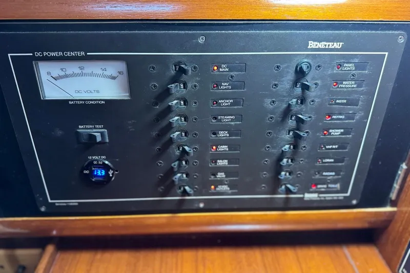 Slide: The Image of Control panel of a 1992 Beneteau Oceanis 370 sailboat, featuring DC power switches. - 36