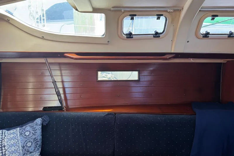 Slide: The Image of Interior of 1992 Beneteau Oceanis 370 sailboat with wooden paneling and cushioned seating. - 37