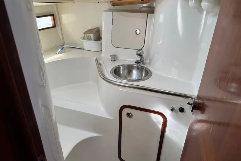 Slide: The Image of Interior of 1992 Beneteau Oceanis 370 yacht bathroom with sink and storage. - 39