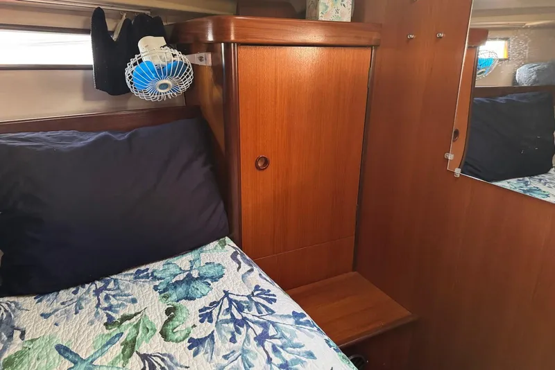 Slide: The Image of Cozy cabin interior of 1992 Beneteau Oceanis 370 sailboat with wooden cabinetry and floral bedding. - 42
