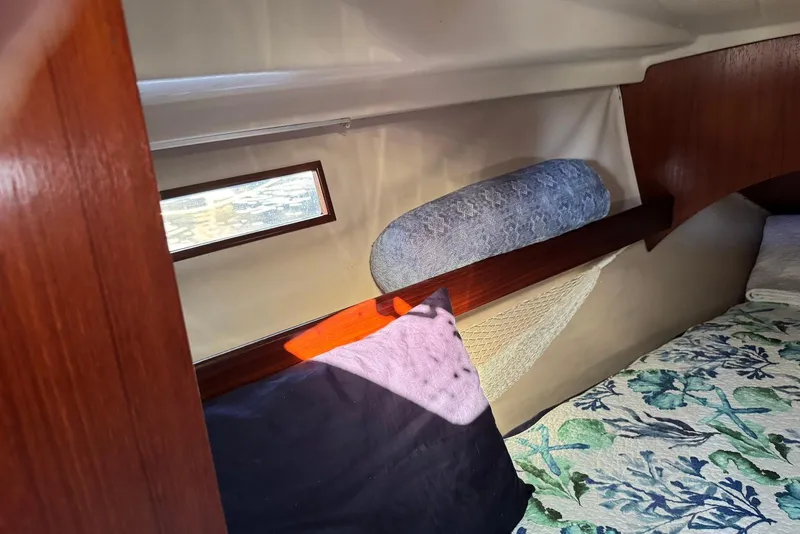 Slide: The Image of Cozy cabin interior of 1992 Beneteau Oceanis 370 sailboat with bedding and window. - 43
