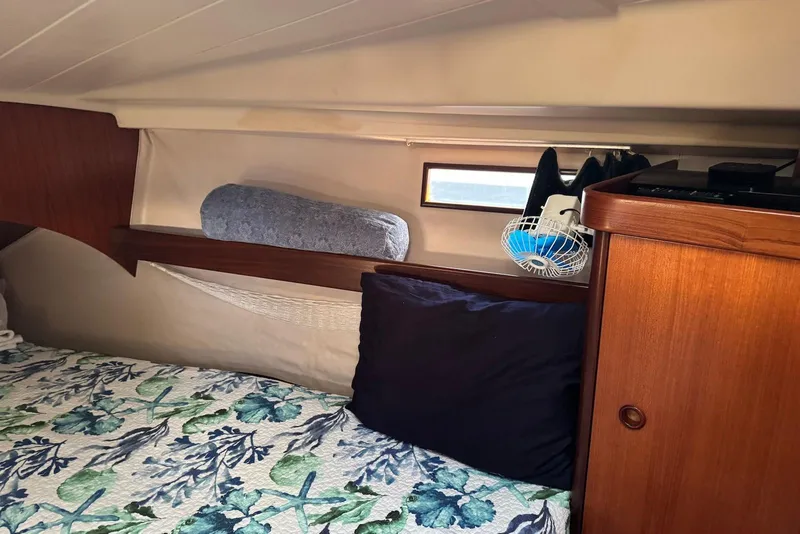 Slide: The Image of Cozy cabin interior of 1992 Beneteau Oceanis 370 sailboat with floral bedding. - 44