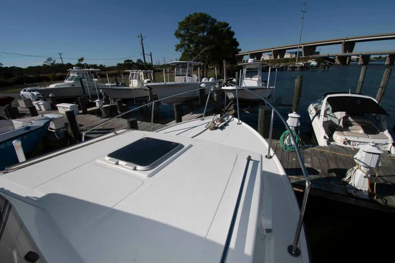 Slide: The Image of 1982 Nauset 27 Downeast Cruiser docked at marina with other boats. - 13