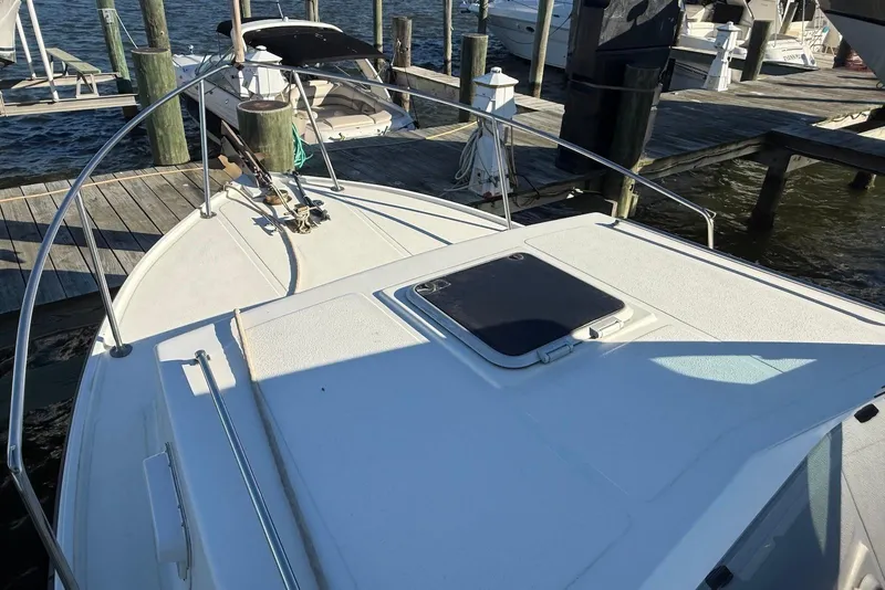 Slide: The Image of 1982 Nauset 27 Downeast Cruiser docked at a marina, showing bow and deck details. - 14