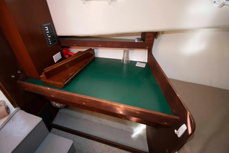 Slide: The Image of Interior of 1982 Nauset 27 Downeast Cruiser with wooden table and electrical panel. - 19