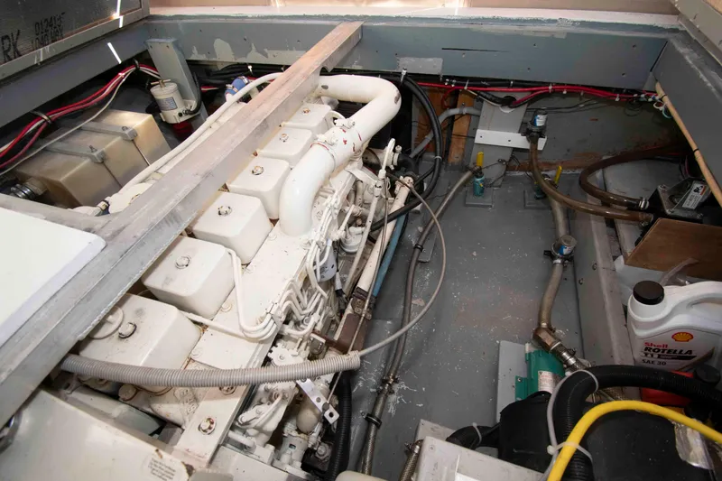 Slide: The Image of Engine room of 1982 Nauset 27 Downeast Cruiser with visible components and wiring. - 21