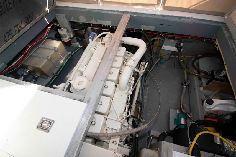 Slide: The Image of Engine compartment of 1982 Nauset 27 Downeast Cruiser with visible wiring and components. - 22