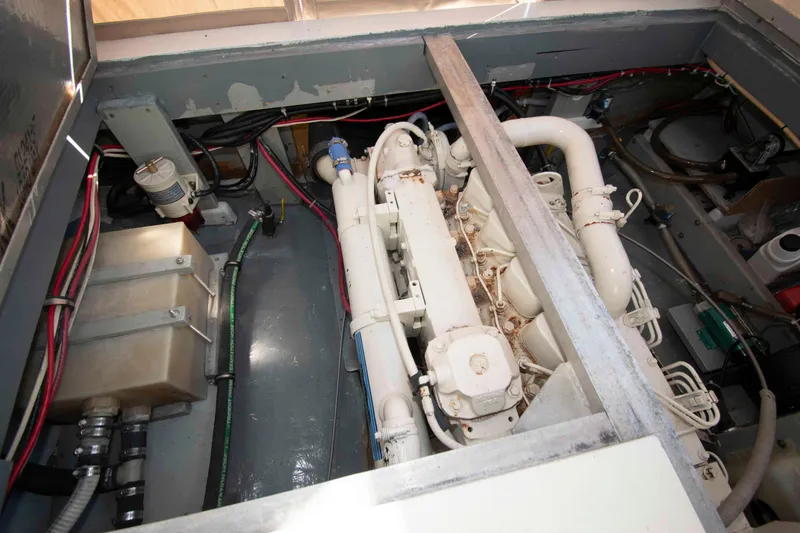 Slide: The Image of Engine compartment of 1982 Nauset 27 Downeast Cruiser, showing mechanical components and wiring. - 23