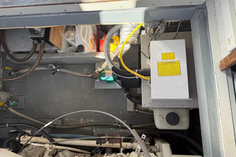 Slide: The Image of Engine compartment of 1982 Nauset 27 Downeast Cruiser with visible wiring and components. - 25