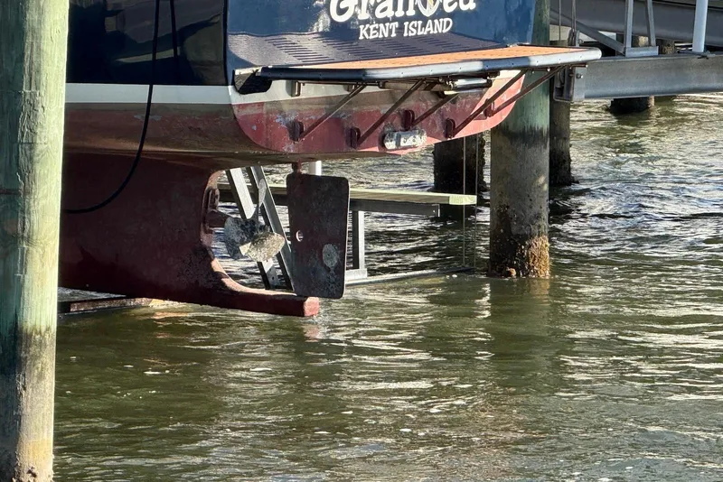 Slide: The Image of 1982 Nauset 27 Downeast Cruiser docked, showing stern and propeller in water. - 7