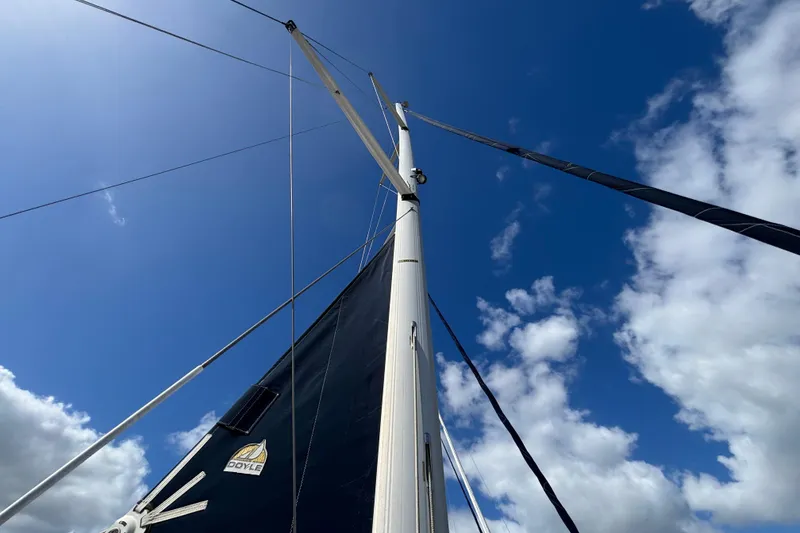 Slide: The Image of Sailboat mast and sails against a blue sky, Hunter 38, 2006 model. - 13