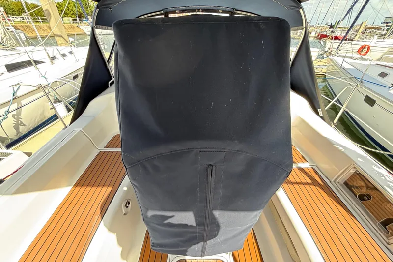 Slide: The Image of 2006 Hunter 38 sailboat cockpit with covered helm, docked at marina. - 15
