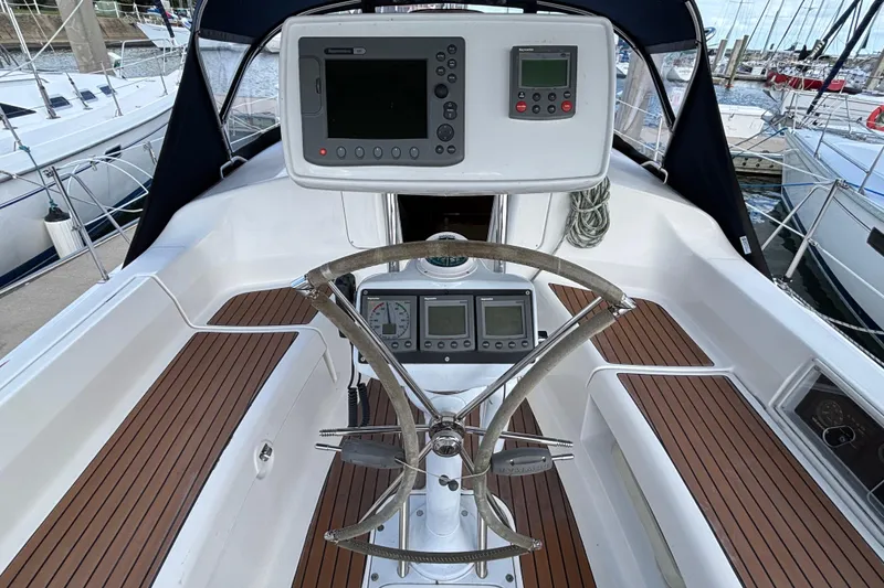 Slide: The Image of Cockpit of 2006 Hunter 38 sailboat with navigation instruments and wooden deck. - 16