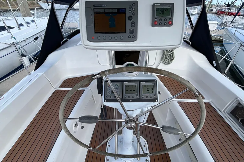 Slide: The Image of Steering wheel and navigation instruments on a 2006 Hunter 38 sailboat cockpit. - 17
