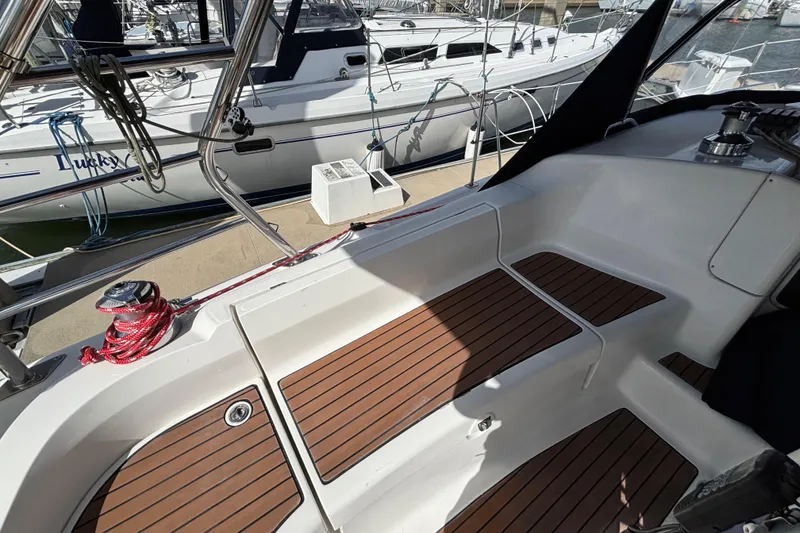 Slide: The Image of Cockpit of 2006 Hunter 38 sailboat with teak flooring and marina view. - 22