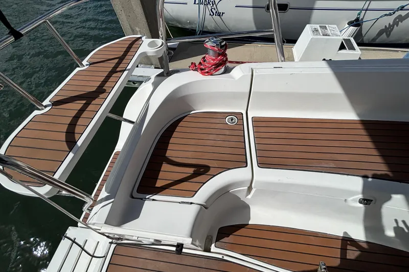 Slide: The Image of Hunter 38 sailboat deck, 2006 model, featuring teak flooring and stainless steel railings. - 24