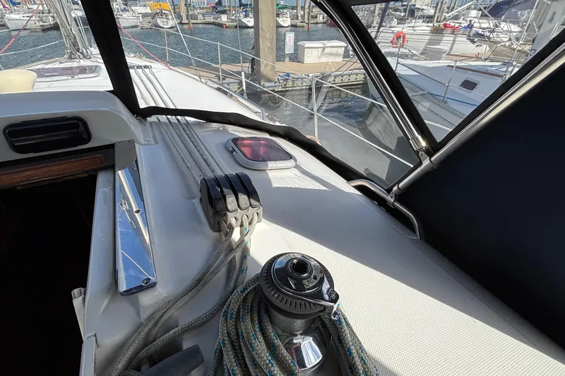 Slide: The Image of Deck view of a 2006 Hunter 38 sailboat in a marina, featuring winch and ropes. - 32