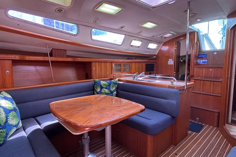 Slide: The Image of Interior of 2006 Hunter 38 sailboat with wooden finishes and cozy seating area. - 34