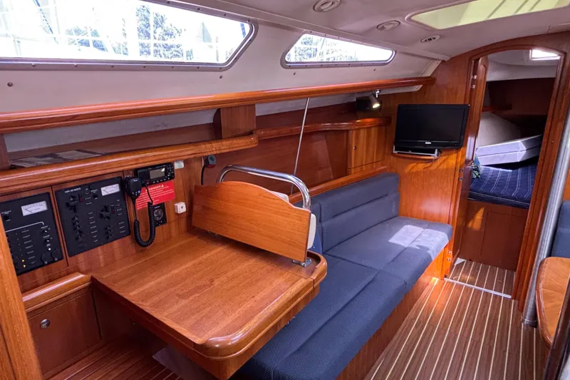 Slide: The Image of Interior of 2006 Hunter 38 sailboat with wood finish and seating area. - 38